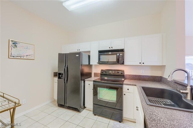 4241 Bellasol Cir Unit 1922, Fort Myers, FL 33916 - kitchen with black appliances, a sink, white cabinets, light tile patterned floors, and baseboards