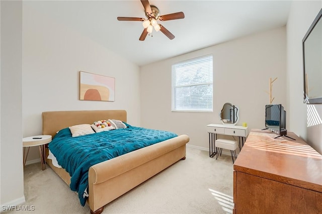 bedroom featuring ceiling fan, light carpet, and vaulted ceiling