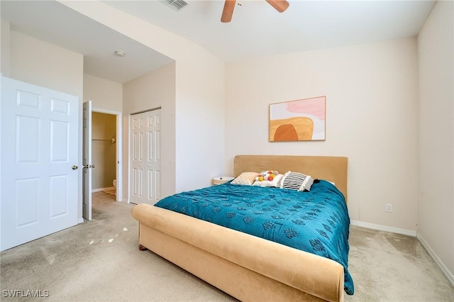 carpeted bedroom featuring a closet and ceiling fan