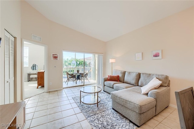 living room featuring high vaulted ceiling and light tile patterned flooring