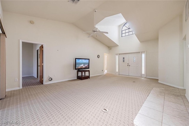 unfurnished living room featuring light carpet, high vaulted ceiling, and ceiling fan