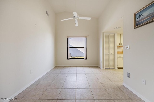 unfurnished room with lofted ceiling, light tile patterned floors, and ceiling fan