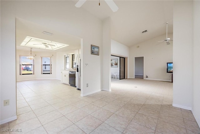 spare room featuring lofted ceiling, light tile patterned floors, and ceiling fan