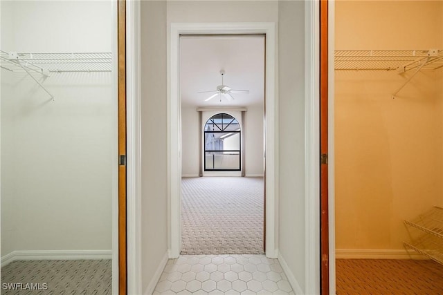 hallway featuring light carpet