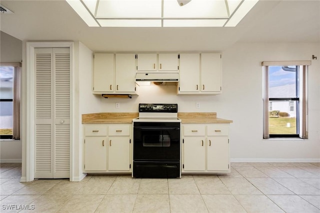 kitchen featuring range with electric stovetop and light tile patterned floors