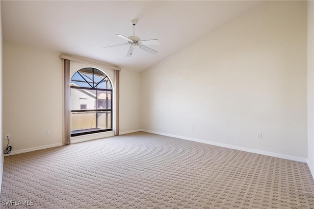 carpeted empty room featuring lofted ceiling and ceiling fan