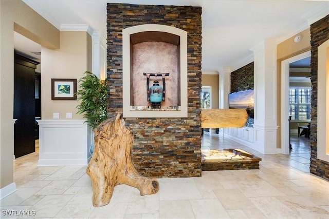 interior space with decorative columns and ornamental molding