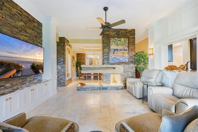 living room featuring ceiling fan and ornamental molding