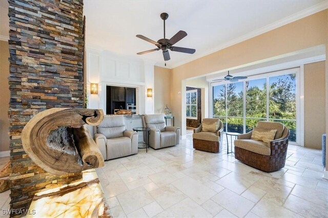 living room with crown molding and ceiling fan