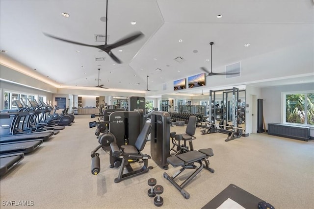 exercise room featuring light carpet, vaulted ceiling, and ceiling fan