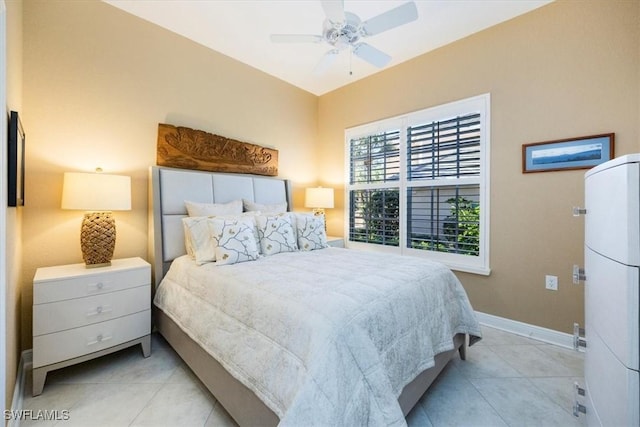 bedroom with ceiling fan and light tile patterned floors