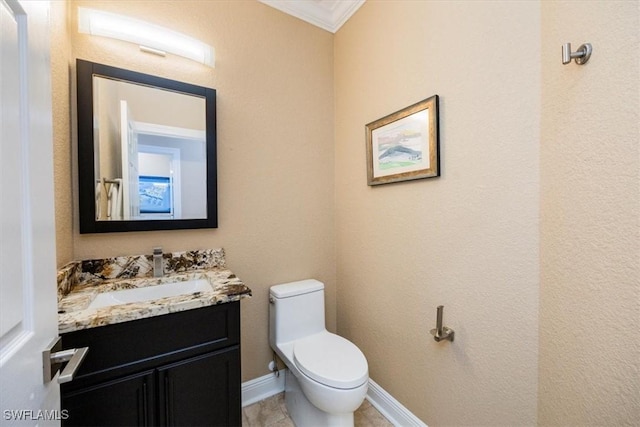 bathroom with tile patterned flooring, vanity, toilet, and ornamental molding