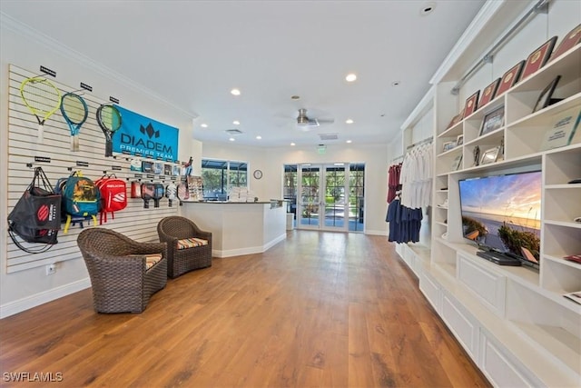 interior space featuring crown molding, light hardwood / wood-style flooring, and french doors