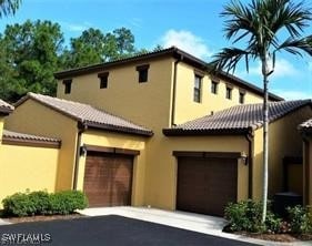 mediterranean / spanish-style house with a garage