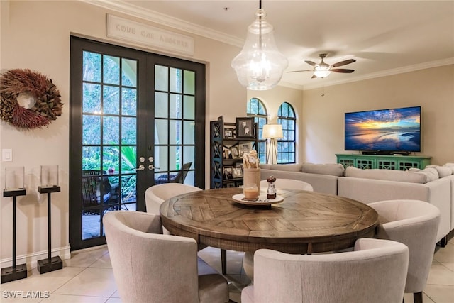 dining room featuring french doors, light tile patterned floors, ceiling fan, and ornamental molding