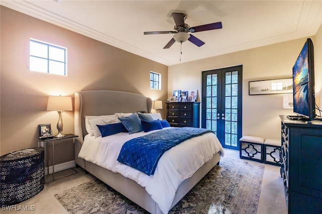 bedroom with multiple windows, ceiling fan, french doors, and ornamental molding