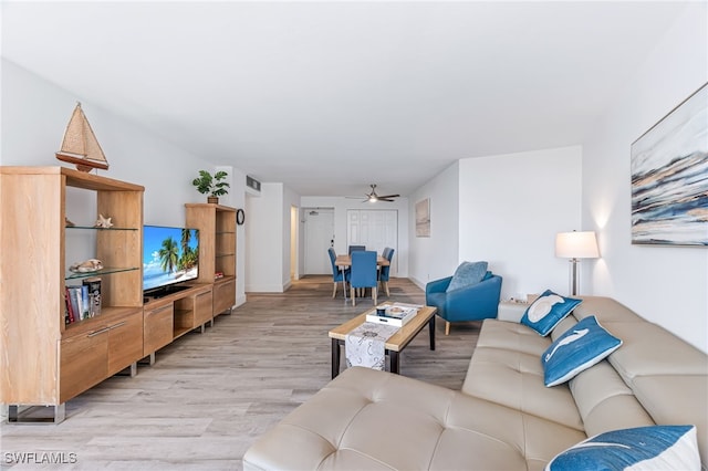 living room with ceiling fan and light hardwood / wood-style floors