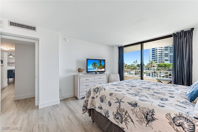 bedroom featuring access to exterior and light hardwood / wood-style flooring