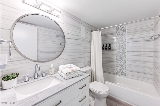 full bathroom featuring vanity, toilet, shower / bathtub combination with curtain, tile walls, and wood-type flooring