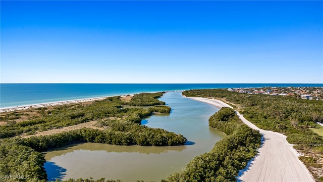 birds eye view of property with a water view and a beach view