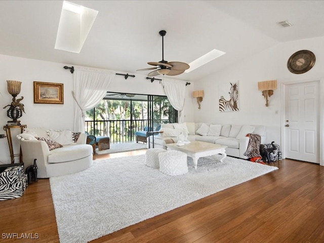 living room with ceiling fan, dark wood-type flooring, and lofted ceiling with skylight