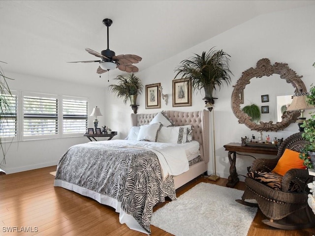 bedroom featuring ceiling fan, lofted ceiling, and hardwood / wood-style flooring