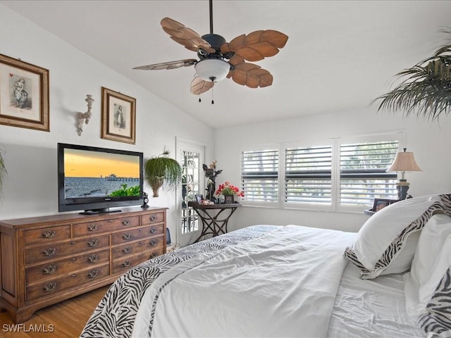 bedroom with ceiling fan, light hardwood / wood-style floors, and lofted ceiling