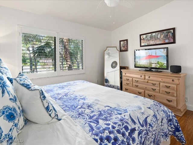 bedroom featuring hardwood / wood-style flooring, ceiling fan, and vaulted ceiling