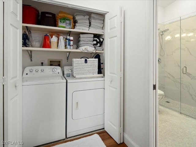 laundry area featuring hardwood / wood-style flooring and washing machine and clothes dryer