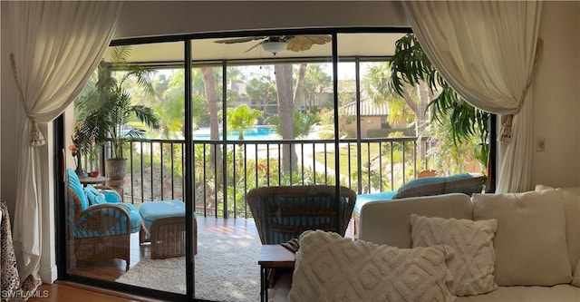 sunroom / solarium featuring ceiling fan