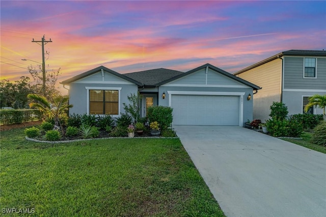 view of front of home with a lawn and a garage