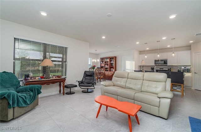 living room featuring plenty of natural light and a chandelier