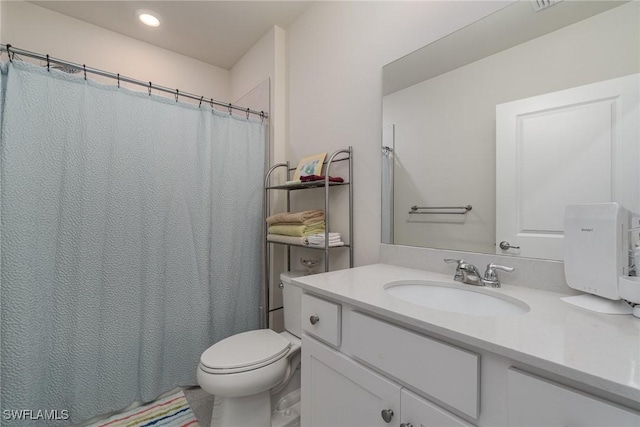 bathroom featuring vanity and toilet