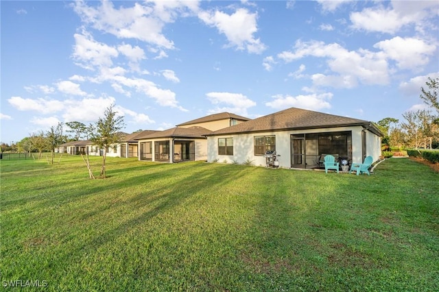 rear view of house with a lawn