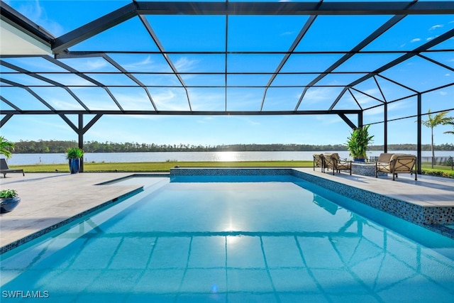 view of swimming pool with glass enclosure, a water view, and a patio