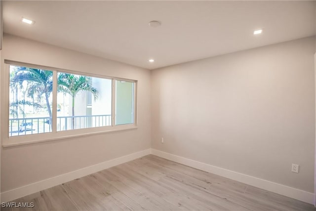 empty room with light hardwood / wood-style floors