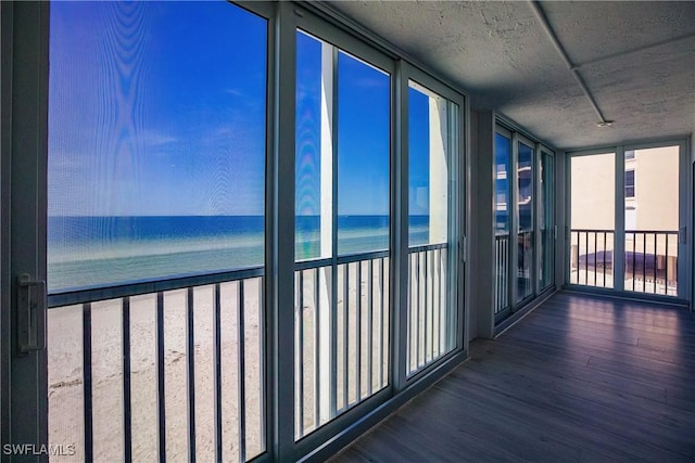 unfurnished sunroom with a water view