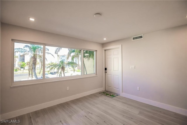 spare room featuring light wood-type flooring