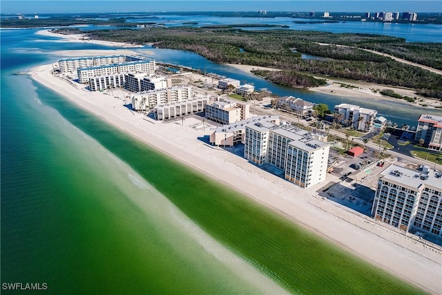 drone / aerial view featuring a water view and a beach view