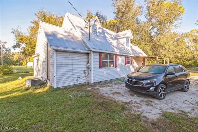 exterior space featuring cooling unit and a yard