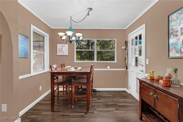 dining area with crown molding, dark hardwood / wood-style floors, and a notable chandelier