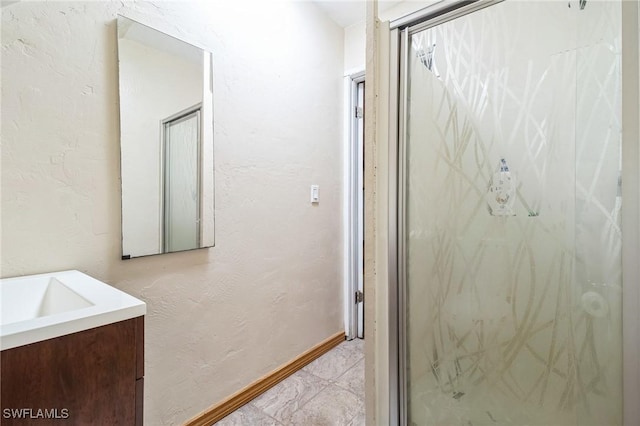 bathroom featuring vanity and a shower with door