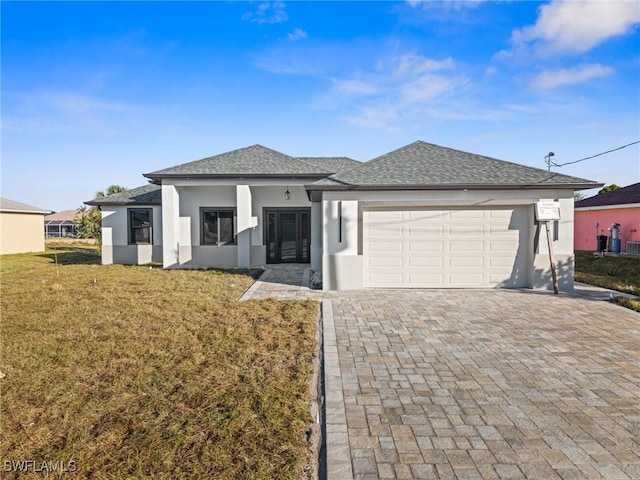 view of front of home with a front yard and a garage