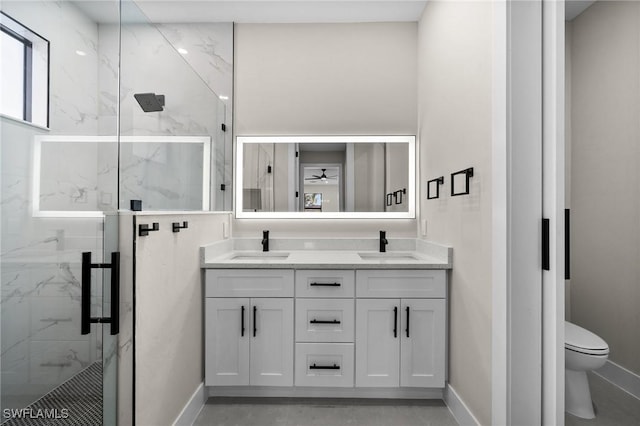 bathroom featuring vanity, a shower with door, toilet, and ceiling fan