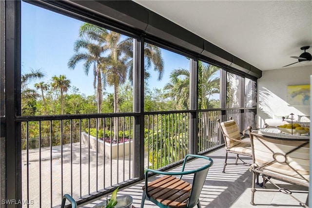 sunroom featuring ceiling fan