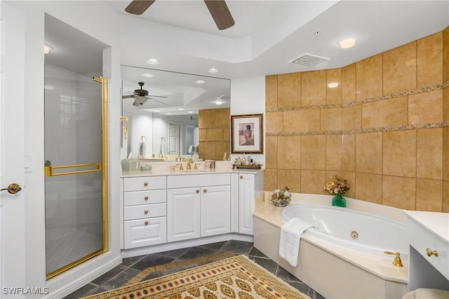 bathroom featuring ceiling fan, vanity, independent shower and bath, and tile walls