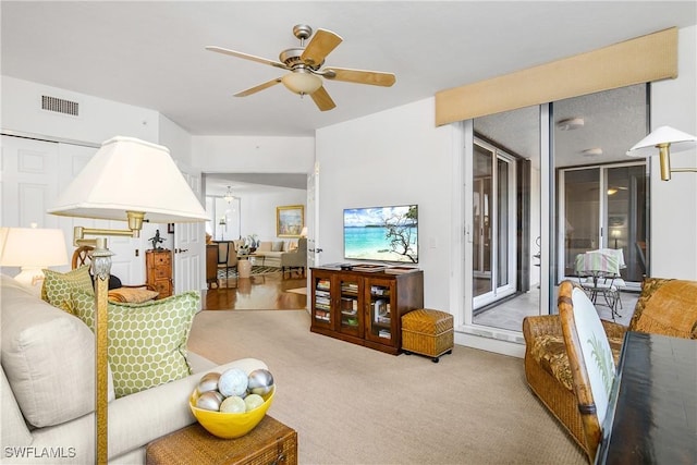 carpeted living room with ceiling fan