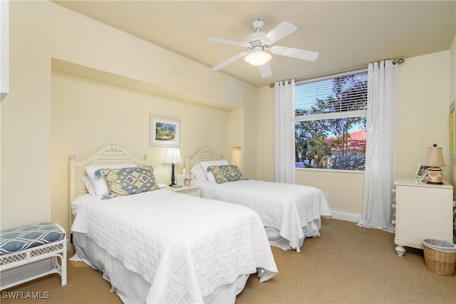 bedroom with ceiling fan and light colored carpet