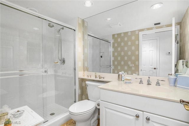 7225 Pelican Bay Blvd Unit 203, Naples, FL 34108 - bathroom with a shower stall, toilet, vanity, and wallpapered walls