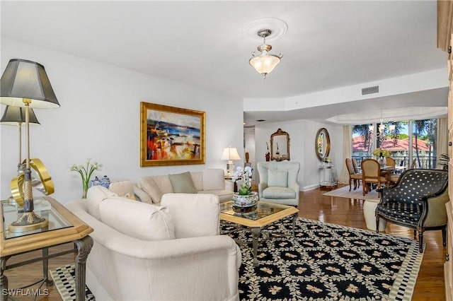 7225 Pelican Bay Blvd Unit 203, Naples, FL 34108 - living area featuring wood finished floors and baseboards